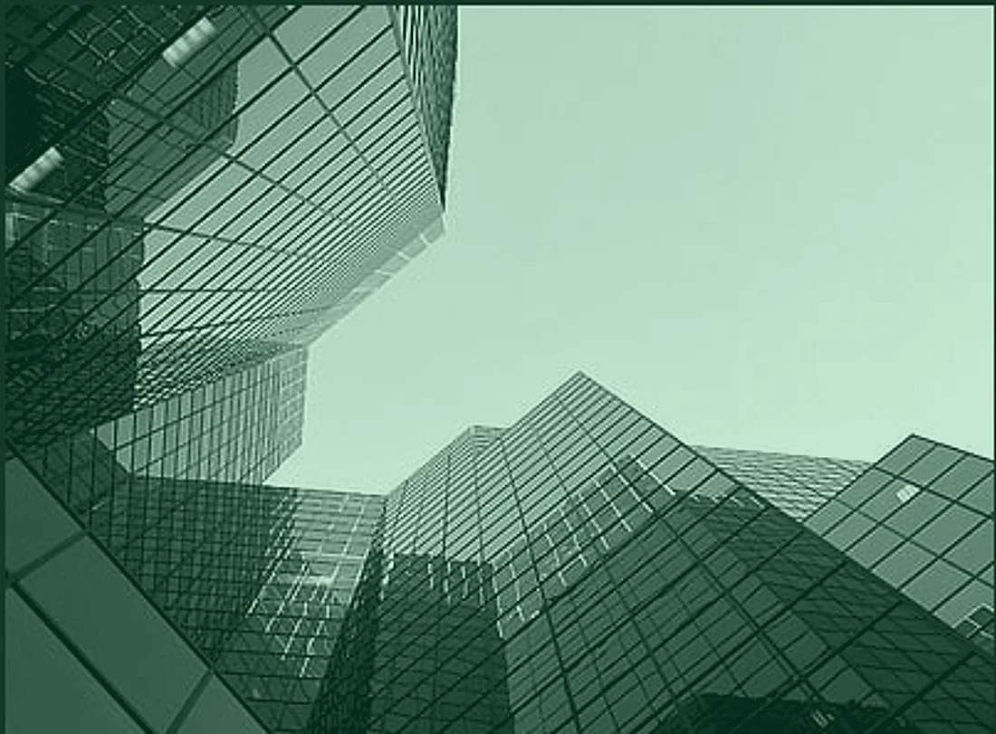 Glass office towers rising against a clear sky